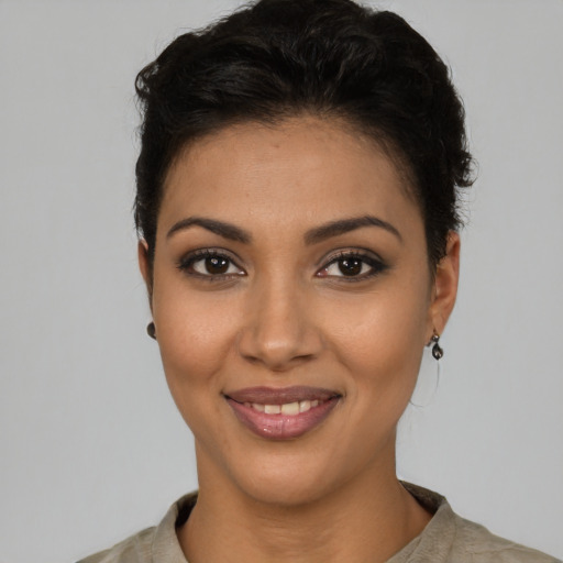 Joyful latino young-adult female with short  brown hair and brown eyes