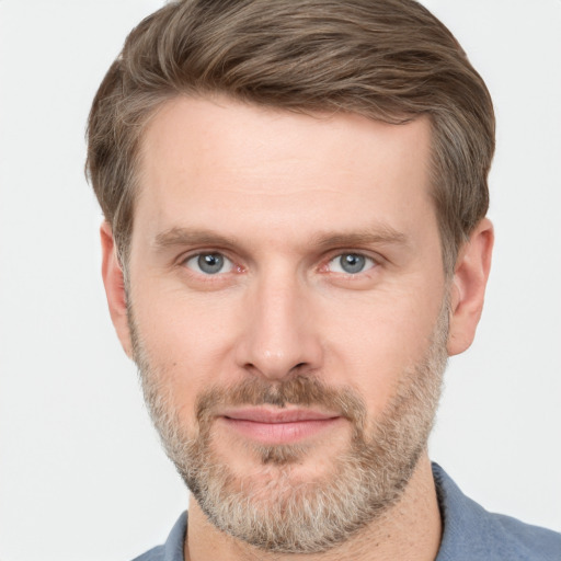 Joyful white adult male with short  brown hair and grey eyes