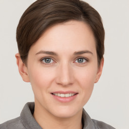 Joyful white young-adult female with short  brown hair and grey eyes