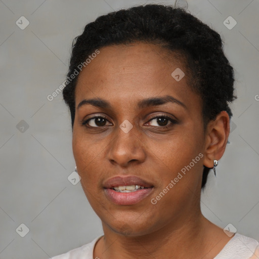 Joyful black young-adult female with short  black hair and brown eyes