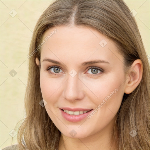 Joyful white young-adult female with long  brown hair and green eyes