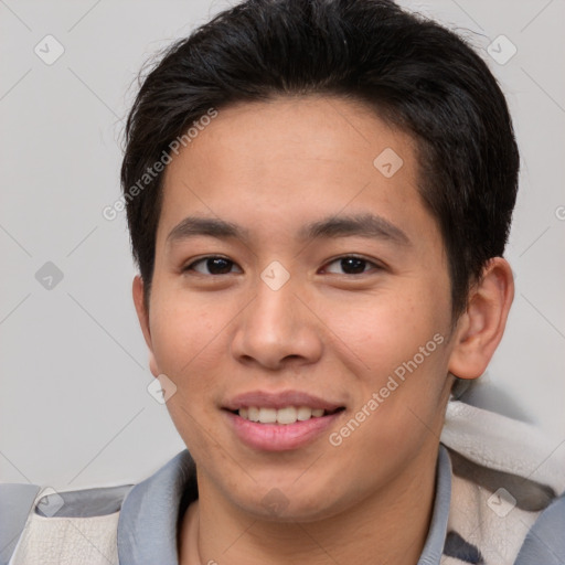 Joyful asian young-adult male with short  brown hair and brown eyes