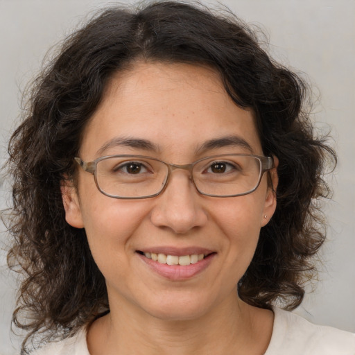 Joyful white adult female with medium  brown hair and brown eyes