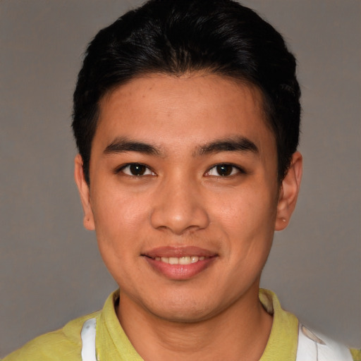 Joyful asian young-adult male with short  brown hair and brown eyes