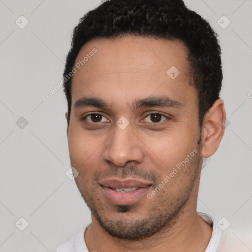 Joyful latino young-adult male with short  black hair and brown eyes