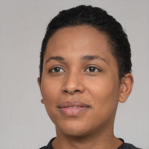 Joyful latino young-adult female with short  black hair and brown eyes