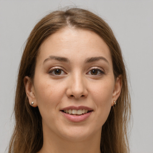 Joyful white young-adult female with long  brown hair and brown eyes