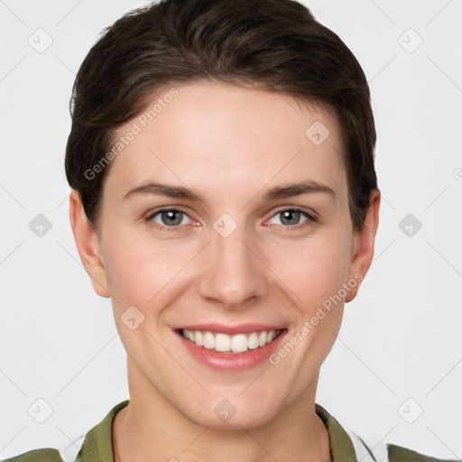 Joyful white young-adult female with short  brown hair and grey eyes