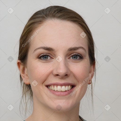 Joyful white young-adult female with medium  brown hair and grey eyes