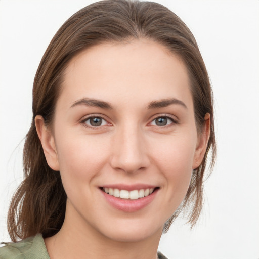 Joyful white young-adult female with medium  brown hair and grey eyes