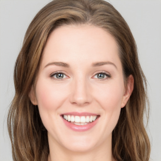 Joyful white young-adult female with long  brown hair and grey eyes