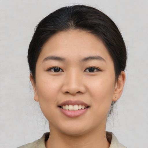 Joyful asian young-adult female with medium  brown hair and brown eyes