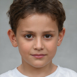 Joyful white child male with short  brown hair and brown eyes