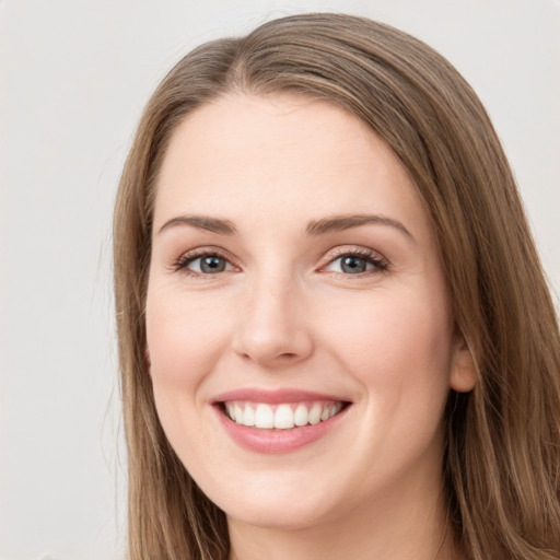 Joyful white young-adult female with long  brown hair and grey eyes