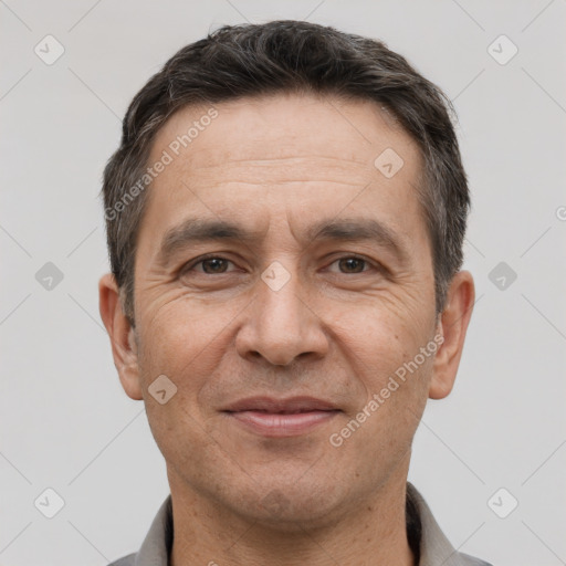 Joyful white adult male with short  brown hair and brown eyes