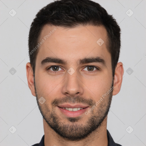 Joyful white young-adult male with short  black hair and brown eyes