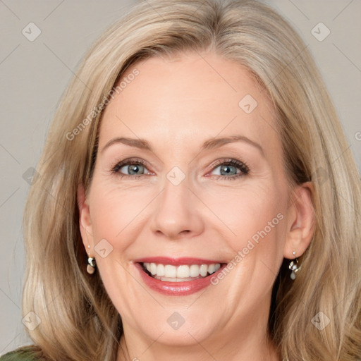 Joyful white adult female with long  brown hair and green eyes