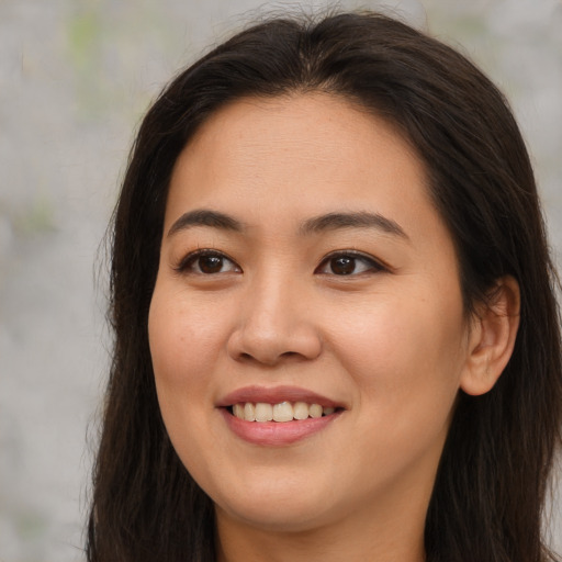 Joyful asian young-adult female with long  brown hair and brown eyes