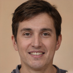 Joyful white young-adult male with short  brown hair and brown eyes