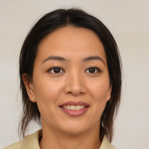 Joyful white young-adult female with medium  brown hair and brown eyes