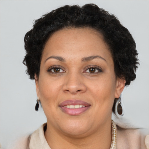 Joyful black adult female with short  brown hair and brown eyes