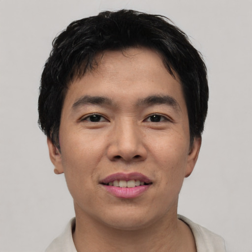 Joyful asian young-adult male with short  black hair and brown eyes