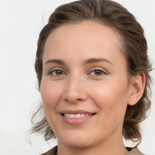 Joyful white young-adult female with medium  brown hair and grey eyes