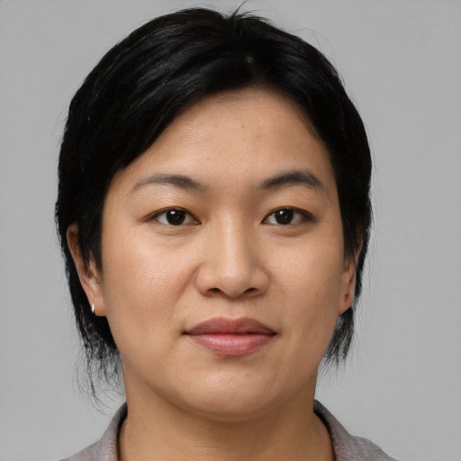 Joyful asian young-adult female with medium  black hair and brown eyes