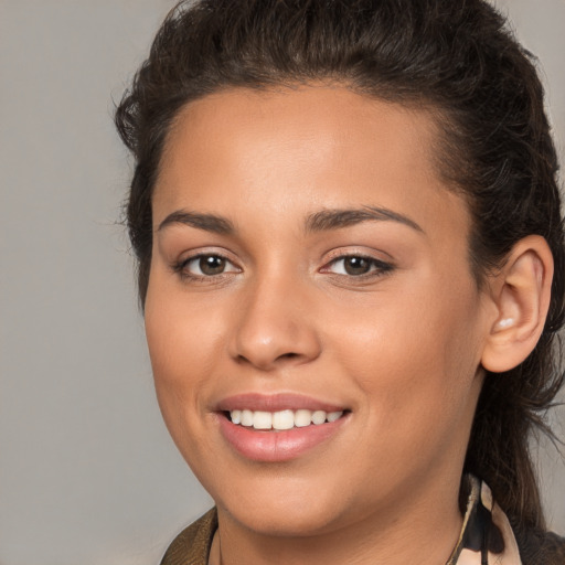 Joyful white young-adult female with long  brown hair and brown eyes