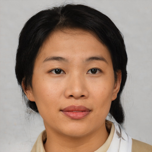 Joyful asian young-adult female with medium  black hair and brown eyes