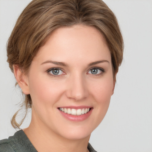 Joyful white young-adult female with medium  brown hair and blue eyes