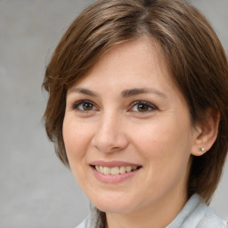 Joyful white adult female with medium  brown hair and brown eyes