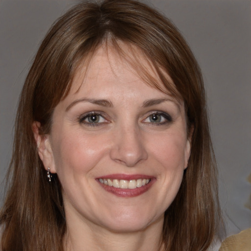 Joyful white adult female with medium  brown hair and grey eyes