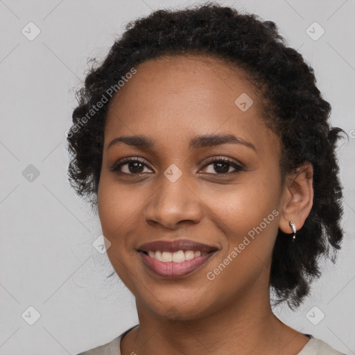 Joyful black young-adult female with long  black hair and brown eyes