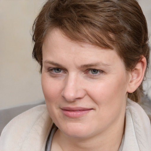 Joyful white young-adult female with medium  brown hair and blue eyes