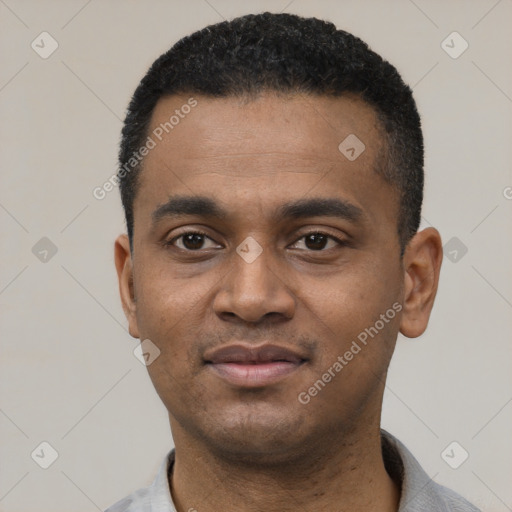 Joyful black young-adult male with short  black hair and brown eyes