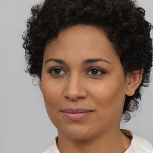 Joyful latino young-adult female with short  brown hair and brown eyes