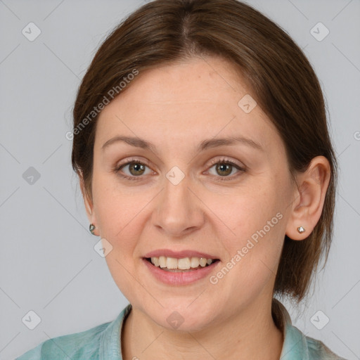 Joyful white adult female with medium  brown hair and grey eyes