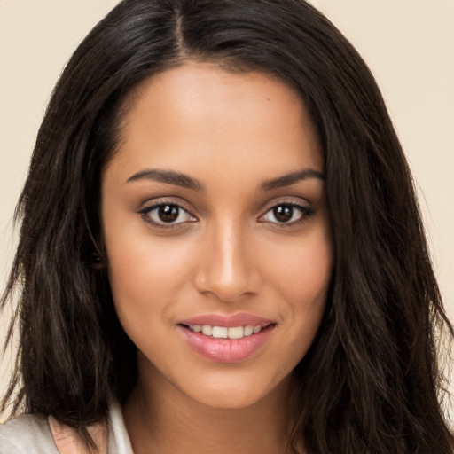 Joyful white young-adult female with long  brown hair and brown eyes