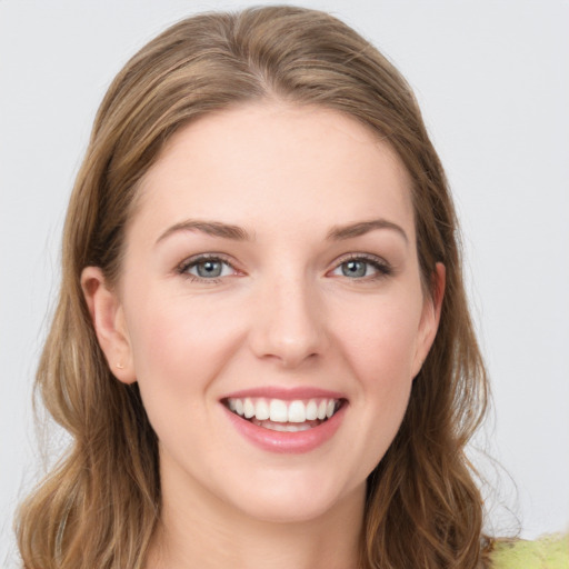 Joyful white young-adult female with long  brown hair and grey eyes