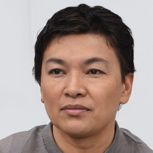 Joyful asian adult male with short  black hair and brown eyes