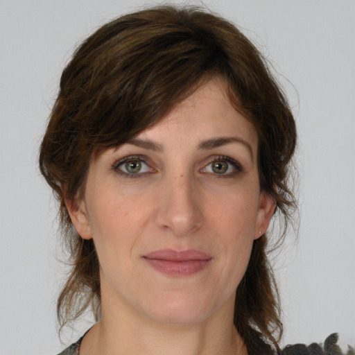 Joyful white young-adult female with medium  brown hair and green eyes