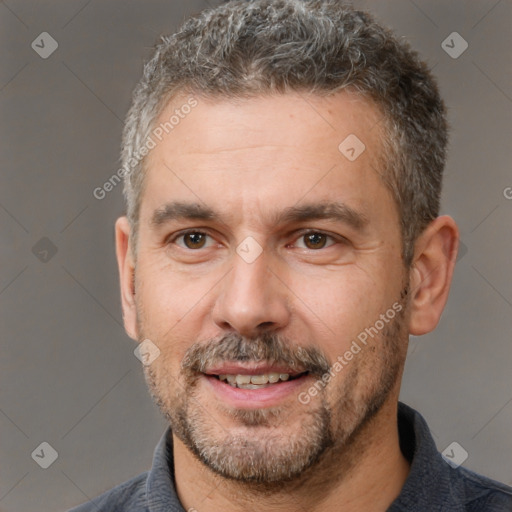 Joyful white adult male with short  brown hair and brown eyes