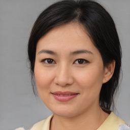 Joyful asian young-adult female with medium  brown hair and brown eyes