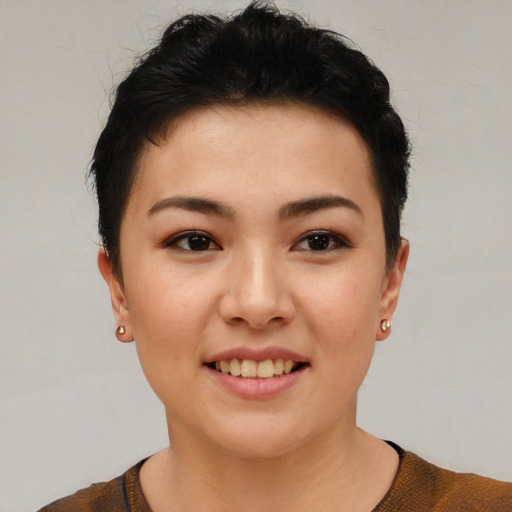 Joyful asian young-adult female with short  brown hair and brown eyes