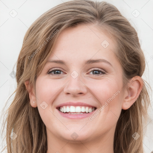 Joyful white young-adult female with long  brown hair and blue eyes