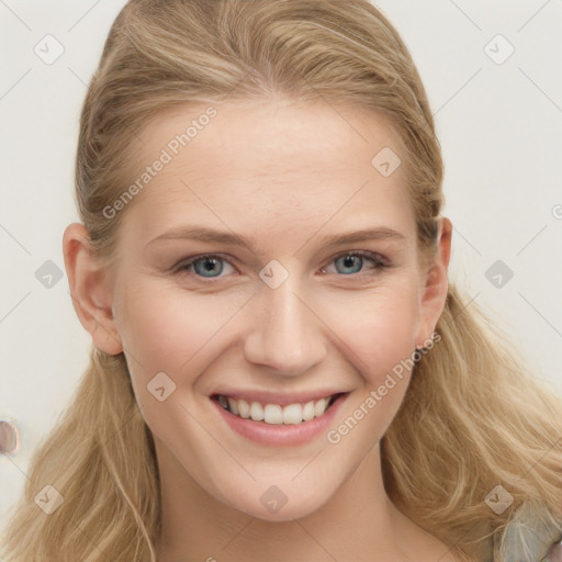 Joyful white young-adult female with long  brown hair and blue eyes