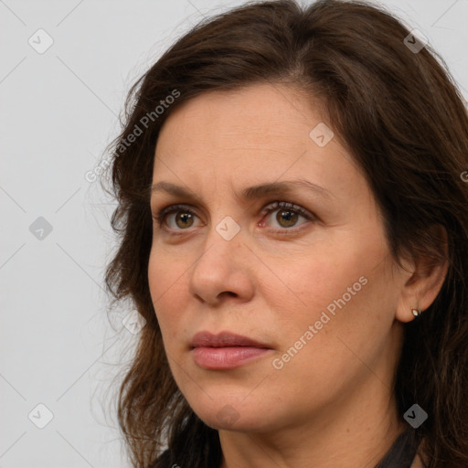 Joyful white adult female with long  brown hair and brown eyes