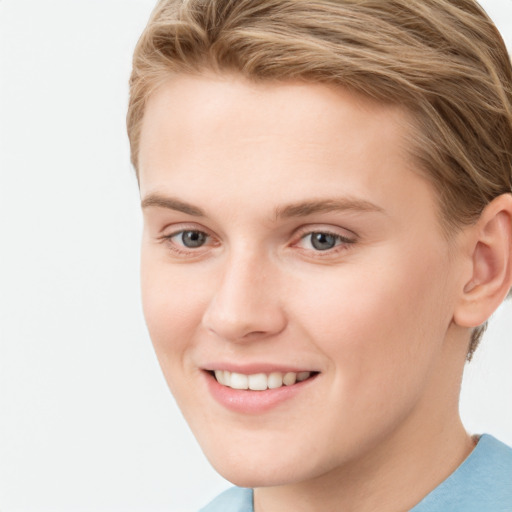 Joyful white young-adult female with short  brown hair and blue eyes