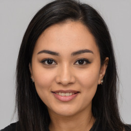 Joyful latino young-adult female with long  brown hair and brown eyes